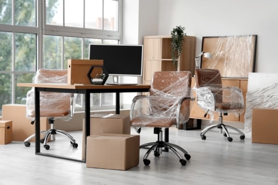 Office chairs and equipment being moved