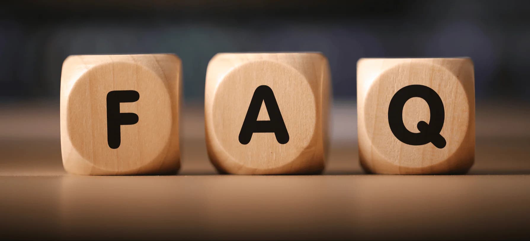 Building blocks in the background that spell out 'F.A.Q'