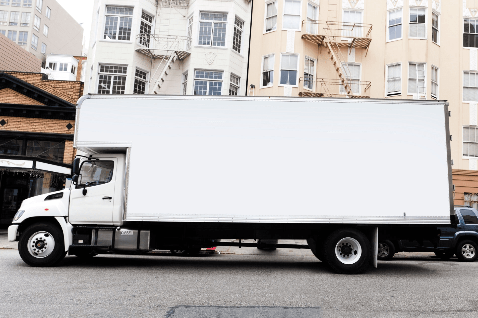 Moving truck driving through a sunny neighborhood