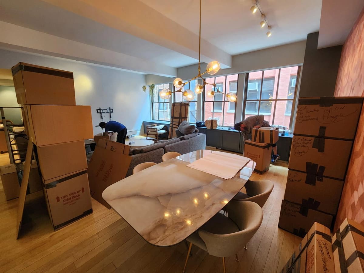 Movers loading boxes into a local moving truck
