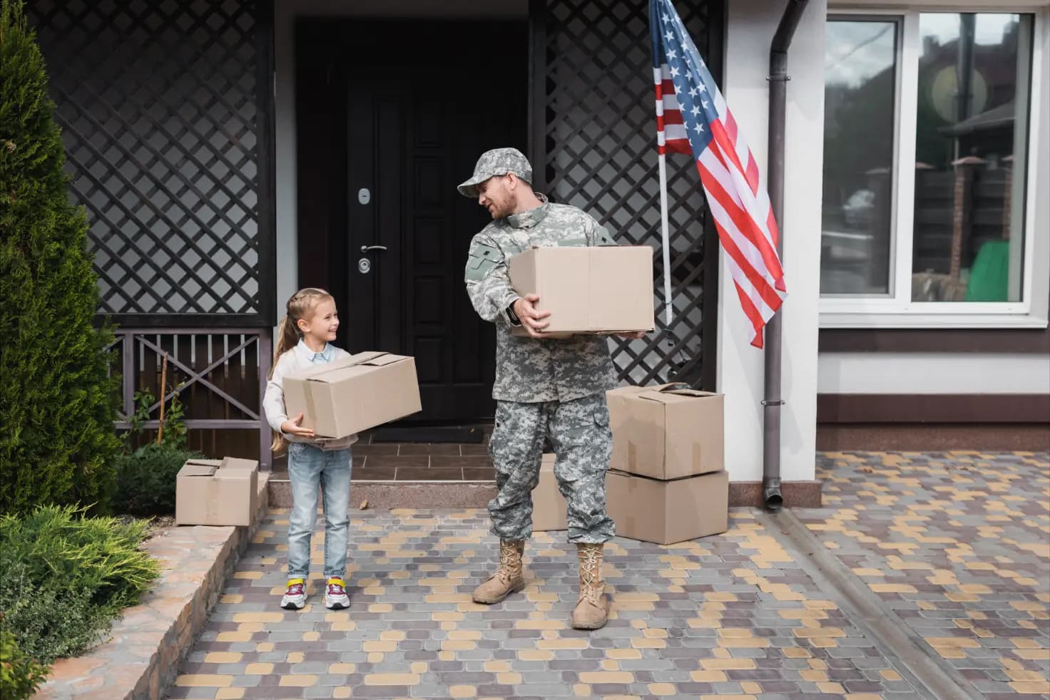 Military family with a moving truck, symbolizing a smooth relocation by Spina's Moving Services
