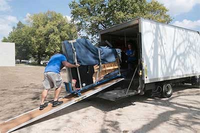 Spina's Moving Services team carefully moving a grand piano