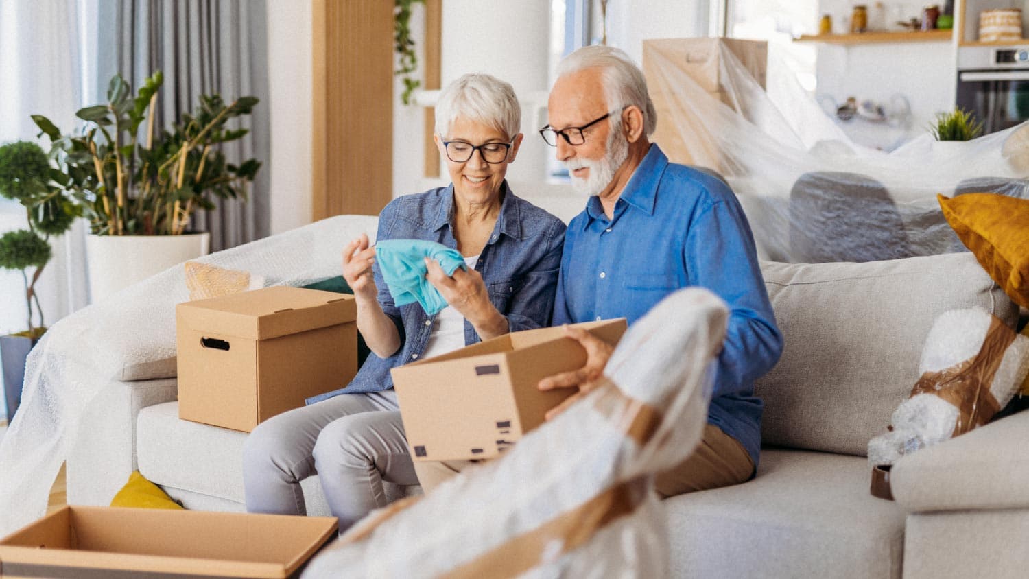 Elderly person smiling comfortably in a new, well-arranged home after a move by Spina's Moving Services